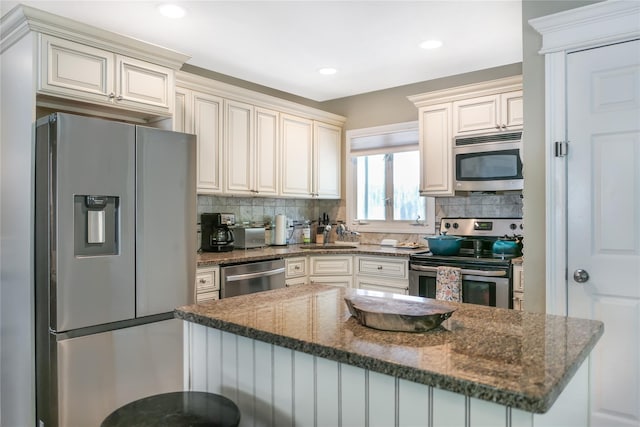 110 Sound Beach Blvd, Sound Beach, NY 11789 - kitchen with appliances with stainless steel finishes, backsplash, dark stone counters, and recessed lighting