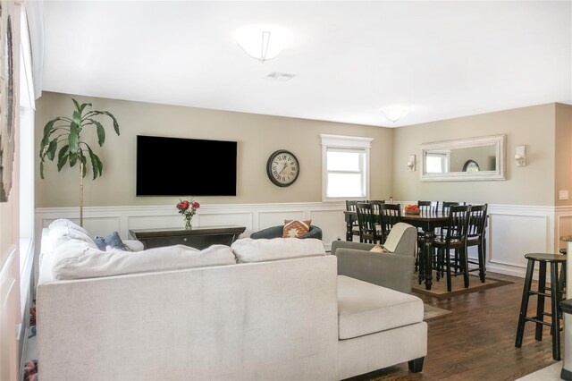 110 Sound Beach Blvd, Sound Beach, NY 11789 - living area featuring a decorative wall, a wainscoted wall, and dark wood-style flooring