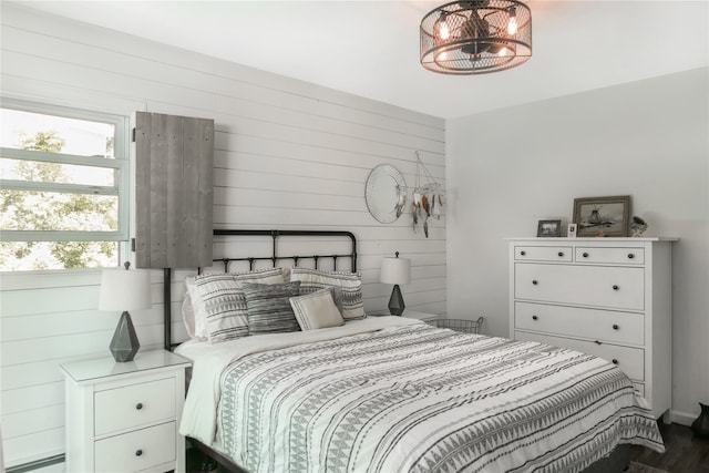 110 Sound Beach Blvd, Sound Beach, NY 11789 - bedroom with wooden walls, wood finished floors, and a baseboard radiator