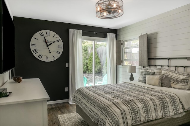 110 Sound Beach Blvd, Sound Beach, NY 11789 - bedroom with multiple windows, dark wood finished floors, baseboards, and a chandelier
