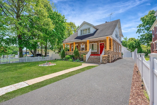 11 Whaley St, Freeport, NY 11520 - bungalow-style house with stone siding, a porch, a shingled roof, and a detached garage