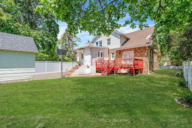 11 Whaley St, Freeport, NY 11520 - back of property with a wooden deck, stairs, and stone siding