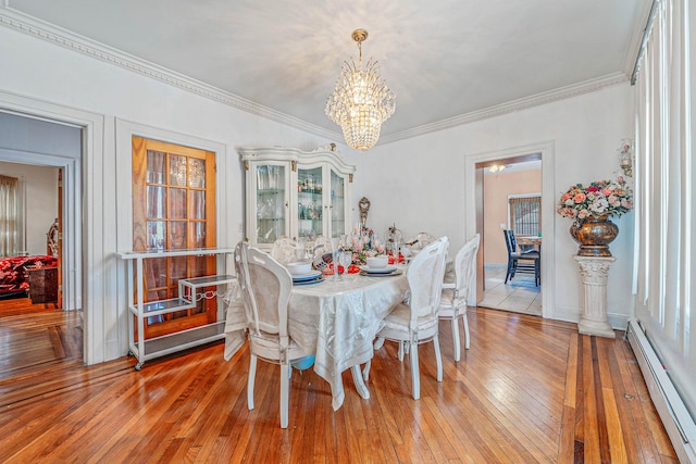 11 Whaley St, Freeport, NY 11520 - dining space with a baseboard radiator, a chandelier, ornamental molding, and light wood-style flooring