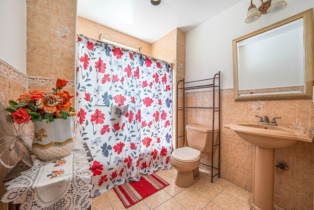 11 Whaley St, Freeport, NY 11520 - full bath featuring toilet, tile walls, curtained shower, tile patterned floors, and a sink