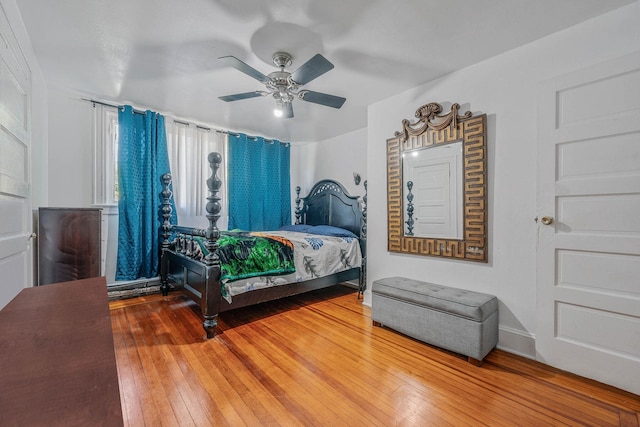 11 Whaley St, Freeport, NY 11520 - bedroom with wood-type flooring, a ceiling fan, and baseboards