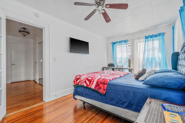 11 Whaley St, Freeport, NY 11520 - bedroom featuring hardwood / wood-style floors, baseboards, a ceiling fan, and crown molding
