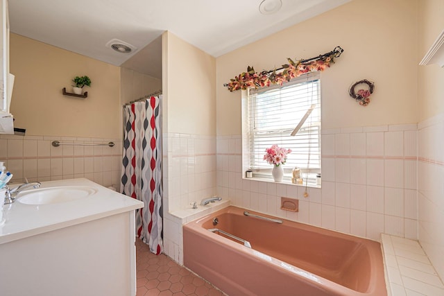 11 Whaley St, Freeport, NY 11520 - full bath featuring tile walls, a garden tub, tile patterned flooring, vanity, and wainscoting