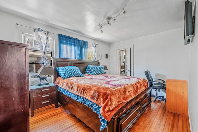 11 Whaley St, Freeport, NY 11520 - bedroom featuring wood-type flooring, rail lighting, and cooling unit