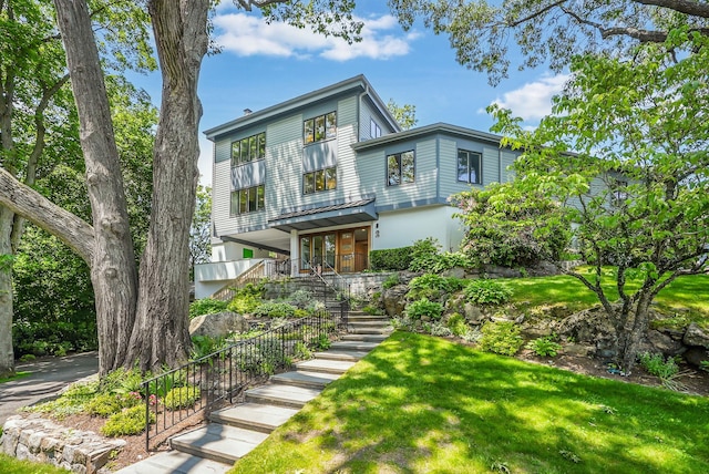 2 Lundy Ln, Larchmont, NY 10538 - contemporary house featuring stairway, a front yard, and covered porch