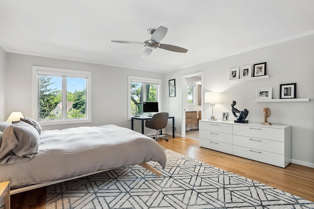 2 Lundy Ln, Larchmont, NY 10538 - bedroom with light wood finished floors, ornamental molding, connected bathroom, baseboards, and ceiling fan