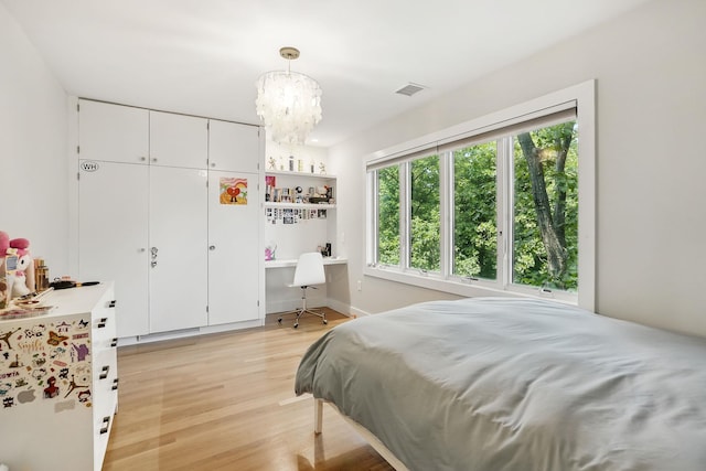 2 Lundy Ln, Larchmont, NY 10538 - bedroom with light wood finished floors, a chandelier, and a desk