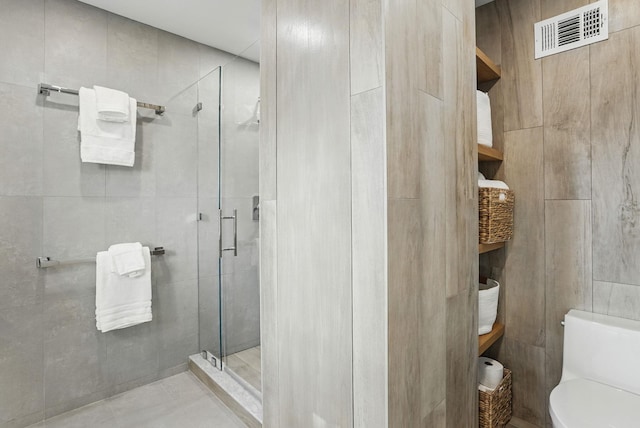 2 Lundy Ln, Larchmont, NY 10538 - bathroom featuring a shower stall, toilet, tile walls, and tile patterned floors