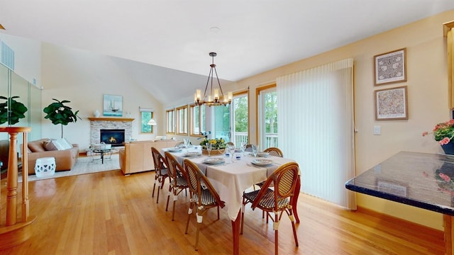 70 Jean Ct, Riverhead, NY 11901 - dining room with a stone fireplace, light wood finished floors, healthy amount of natural light, and lofted ceiling