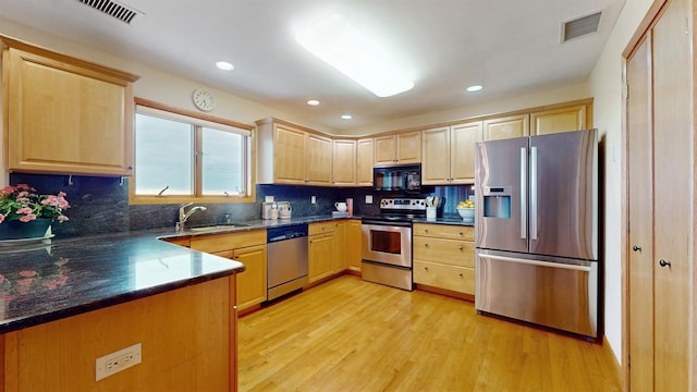 70 Jean Ct, Riverhead, NY 11901 - kitchen with stainless steel appliances, light brown cabinets, a sink, light wood-type flooring, and decorative backsplash