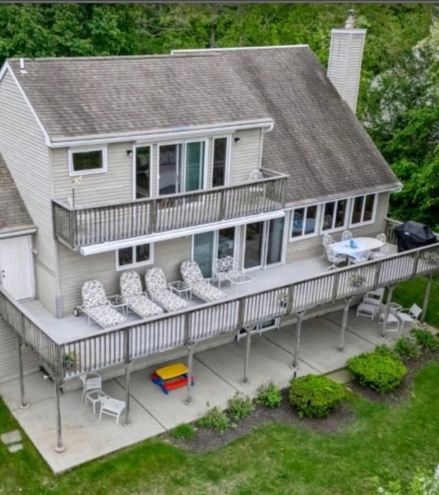 70 Jean Ct, Riverhead, NY 11901 - rear view of house with a chimney, roof with shingles, and a patio