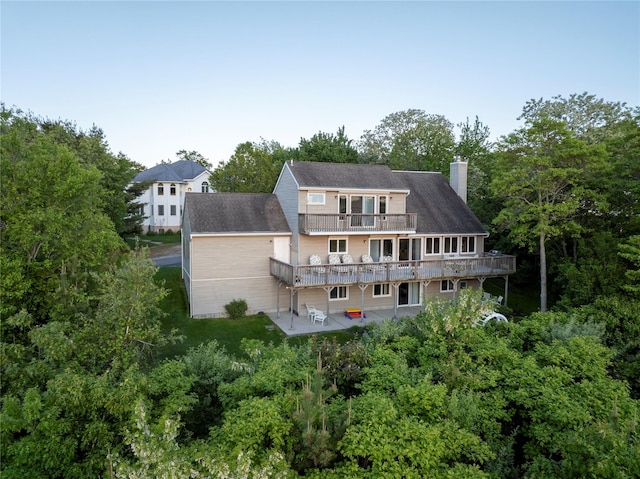 70 Jean Ct, Riverhead, NY 11901 - rear view of house with a patio, a balcony, a deck, and a chimney