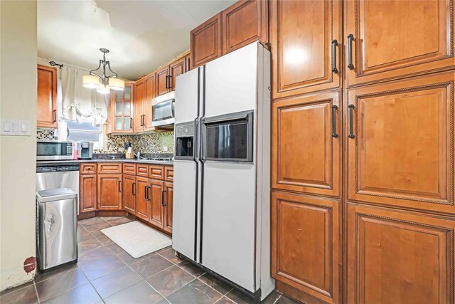 225-35 106th Ave, Queens Village, NY 11429 - kitchen with white refrigerator with ice dispenser, stainless steel microwave, brown cabinetry, and decorative backsplash