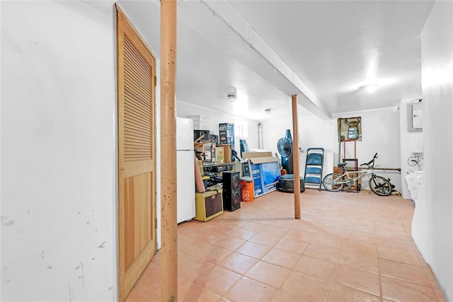 225-35 106th Ave, Queens Village, NY 11429 - finished below grade area with freestanding refrigerator and light tile patterned floors
