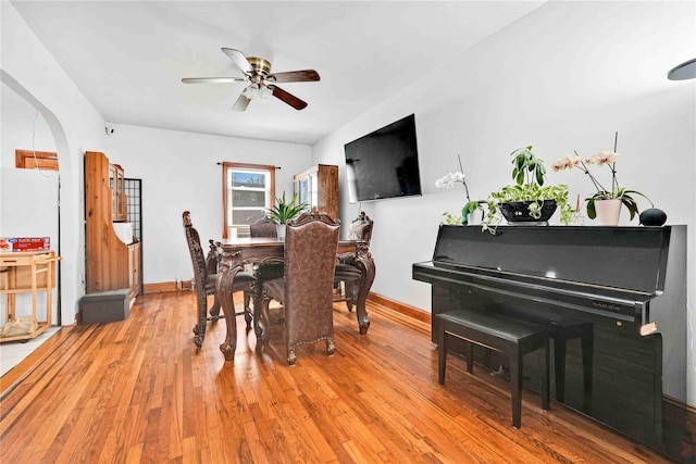 113-23 204th St, Saint Albans, NY 11412 - dining area featuring ceiling fan, light wood-style floors, baseboards, and arched walkways