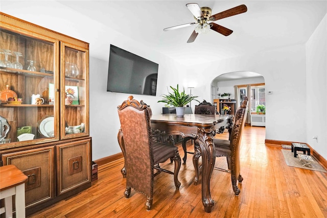 113-23 204th St, Saint Albans, NY 11412 - dining space featuring arched walkways, baseboards, ceiling fan, and light wood finished floors