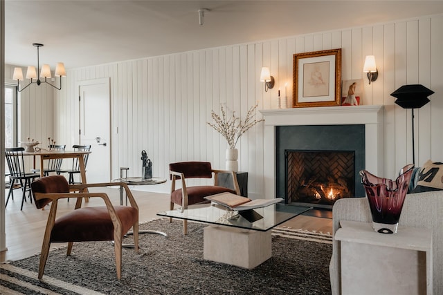 258 Fox Run Rd, Salt Point, NY 12578 - living room with wood finished floors, a chandelier, and a lit fireplace
