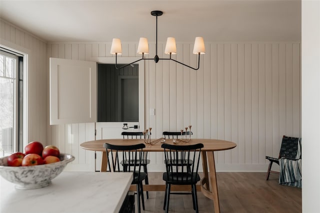 258 Fox Run Rd, Salt Point, NY 12578 - dining space featuring wood finished floors, a chandelier, baseboards, and wooden walls