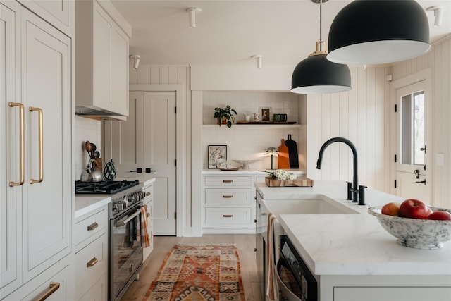 258 Fox Run Rd, Salt Point, NY 12578 - kitchen featuring high end stainless steel range oven, a center island with sink, backsplash, dishwashing machine, and white cabinets