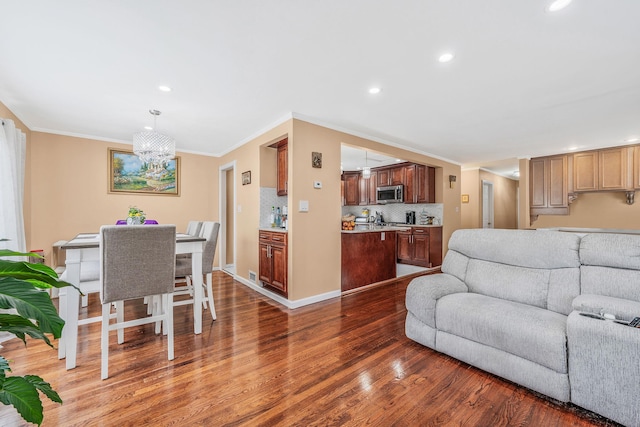 5 Willets Dr, Syosset, NY 11791 - living room with wood finished floors, recessed lighting, ornamental molding, and a chandelier