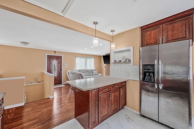 5 Willets Dr, Syosset, NY 11791 - kitchen with stainless steel fridge with ice dispenser, a peninsula, light countertops, tasteful backsplash, and pendant lighting