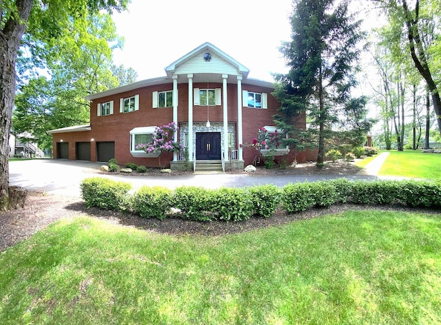 12 Sophia St, Monsey, NY 10952 - neoclassical / greek revival house featuring driveway, a garage, and a front lawn