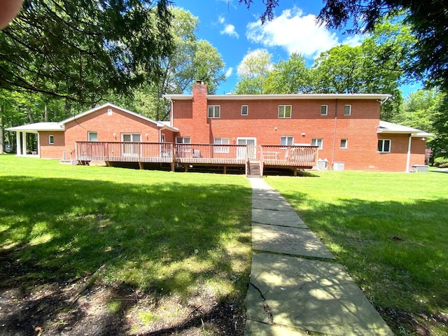 12 Sophia St, Monsey, NY 10952 - back of house featuring a wooden deck, brick siding, and a lawn