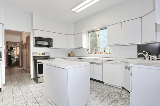 12 Sophia St, Monsey, NY 10952 - kitchen with white dishwasher, stainless steel gas range oven, black microwave, light countertops, and white cabinetry