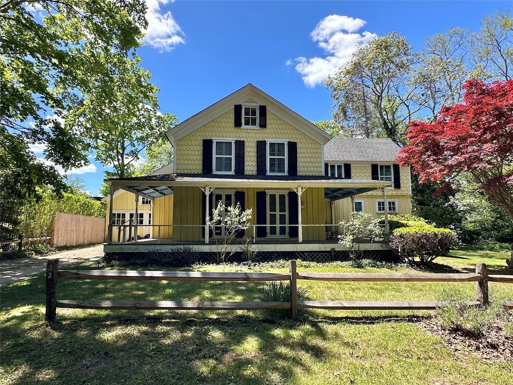 33 Woodbridge Ln, Quiogue, NY 11978 - rear view of property with covered porch, french doors, and board and batten siding