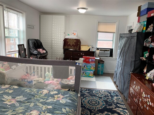 42-40 Bowne St Unit 5C, Flushing, NY 11355 - bedroom featuring cooling unit, tile patterned floors, and baseboards