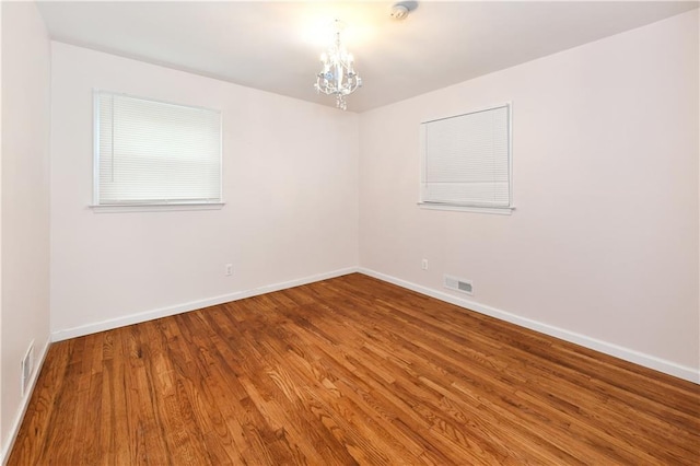 11 Brookview Blvd, Chestnut Ridge, NY 10977 - spare room featuring a chandelier, wood finished floors, and baseboards