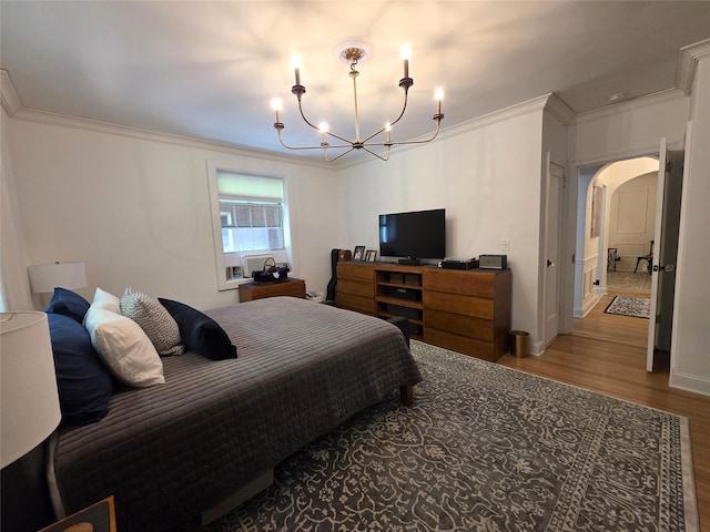 117-01 Park Ln S Unit A3C, Kew Gardens, NY 11415 - bedroom featuring arched walkways, wood finished floors, ornamental molding, a chandelier, and baseboards