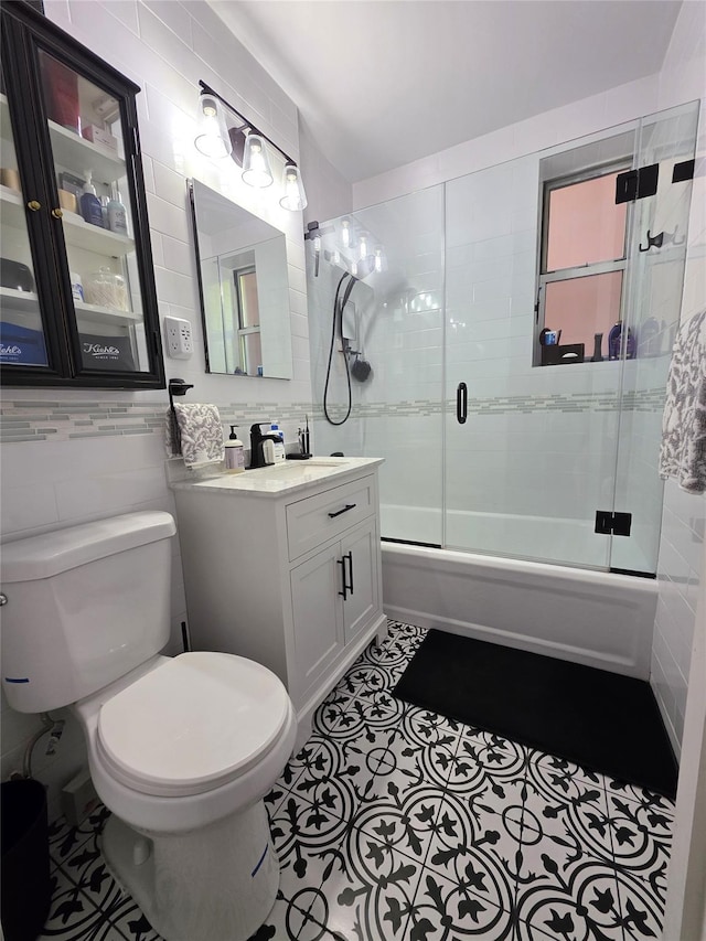 117-01 Park Ln S Unit A3C, Kew Gardens, NY 11415 - full bath with tile walls, enclosed tub / shower combo, toilet, vanity, and tile patterned floors