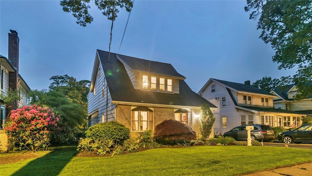 110 Driscoll Ave, Rockville Centre, NY 11570 - view of front of house featuring brick siding and a front lawn