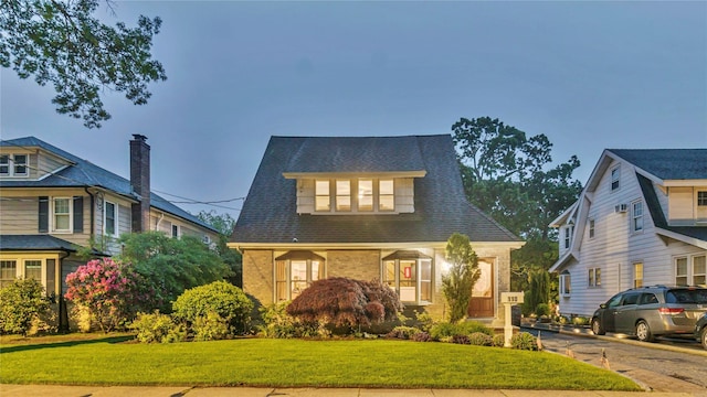 110 Driscoll Ave, Rockville Centre, NY 11570 - view of front of home with a front lawn and brick siding