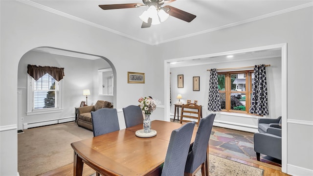 110 Driscoll Ave, Rockville Centre, NY 11570 - dining space with arched walkways, a baseboard radiator, ceiling fan, and crown molding