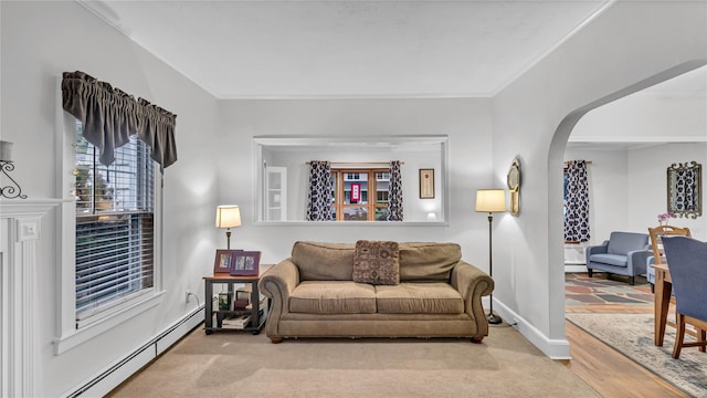 110 Driscoll Ave, Rockville Centre, NY 11570 - living area with baseboard heating, arched walkways, ornamental molding, and baseboards
