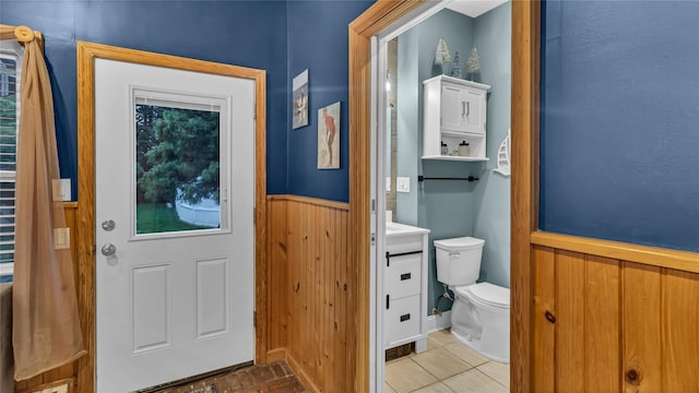 110 Driscoll Ave, Rockville Centre, NY 11570 - bathroom featuring toilet, a wainscoted wall, wood walls, and vanity