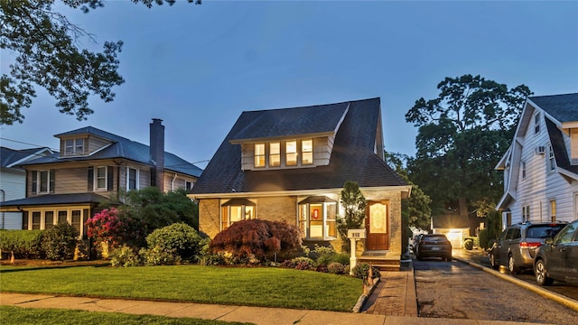 110 Driscoll Ave, Rockville Centre, NY 11570 - view of front of home featuring brick siding, asphalt driveway, and a front lawn