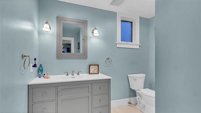 110 Driscoll Ave, Rockville Centre, NY 11570 - bathroom featuring vanity, toilet, baseboards, and tile patterned flooring