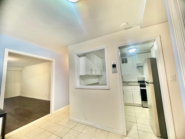60-11 Broadway Unit L2, Woodside, NY 11377 - hall with light tile patterned floors and baseboards