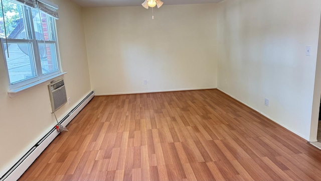 15307 79th Ave, Flushing, NY 11367 - empty room featuring light wood finished floors, ceiling fan, an AC wall unit, and baseboards