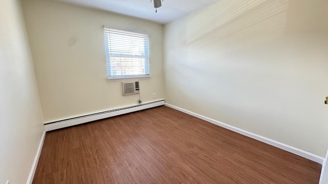 15307 79th Ave, Flushing, NY 11367 - empty room with a baseboard radiator, baseboards, dark wood finished floors, a wall mounted AC, and a ceiling fan