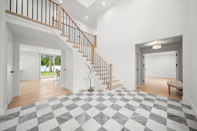 14 Kennedy Ln, West Islip, NY 11795 - foyer featuring stairs, recessed lighting, a high ceiling, light wood finished floors, and baseboards