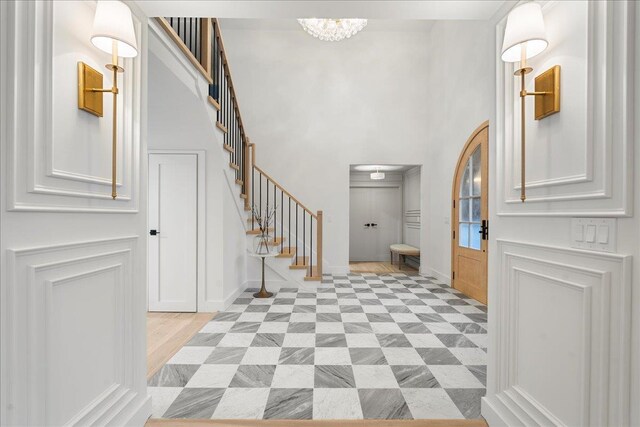 14 Kennedy Ln, West Islip, NY 11795 - entrance foyer featuring stairway, a chandelier, baseboards, and a high ceiling