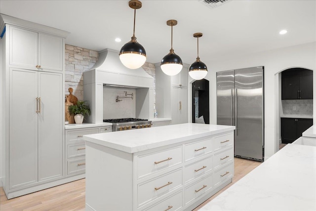 14 Kennedy Ln, West Islip, NY 11795 - kitchen with high quality fridge, light wood-style flooring, light stone countertops, hanging light fixtures, and recessed lighting